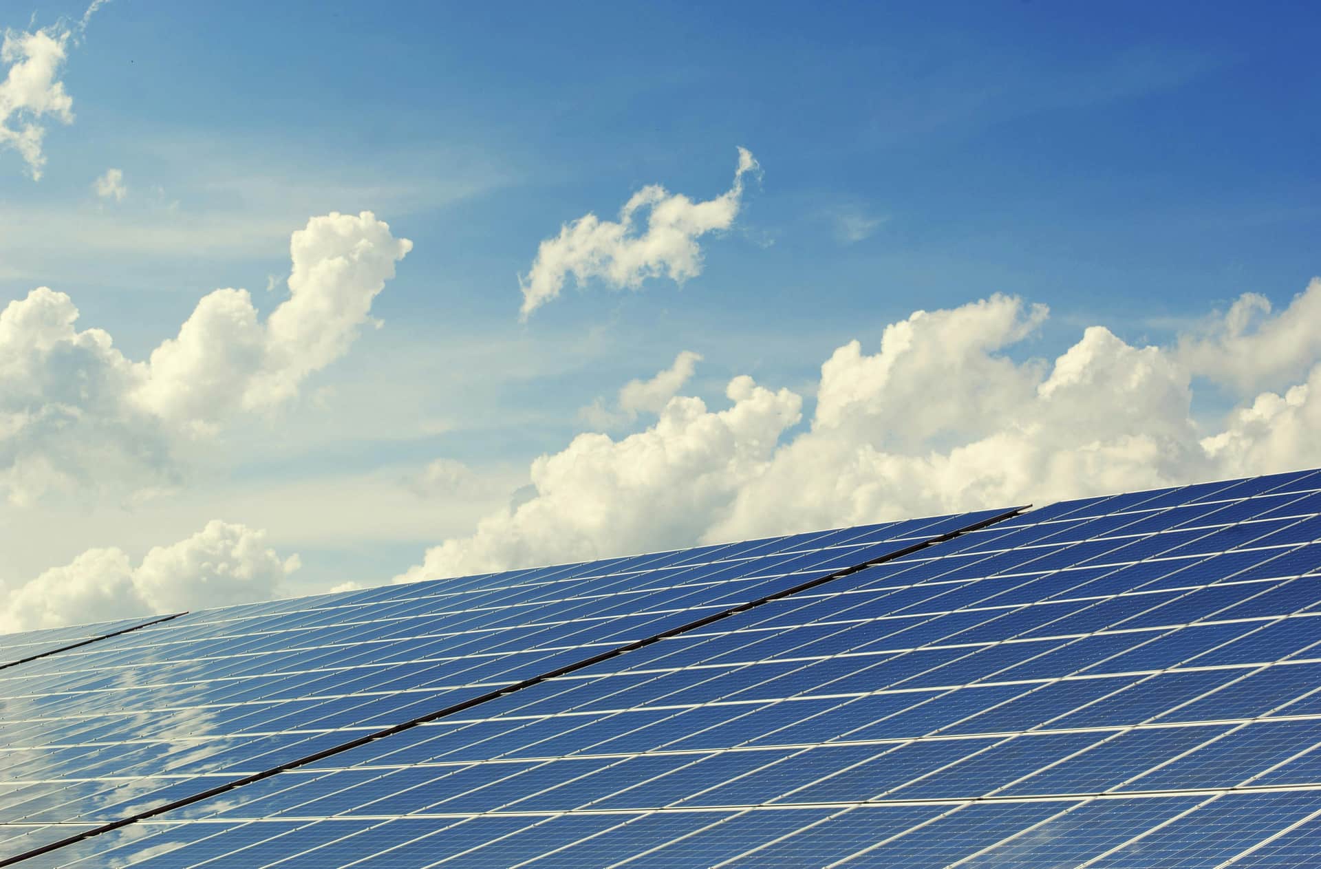 Solar panels under blue sky - sustainable energy infrastructure